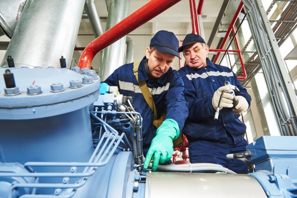 Two technicians repairing Air Compressor